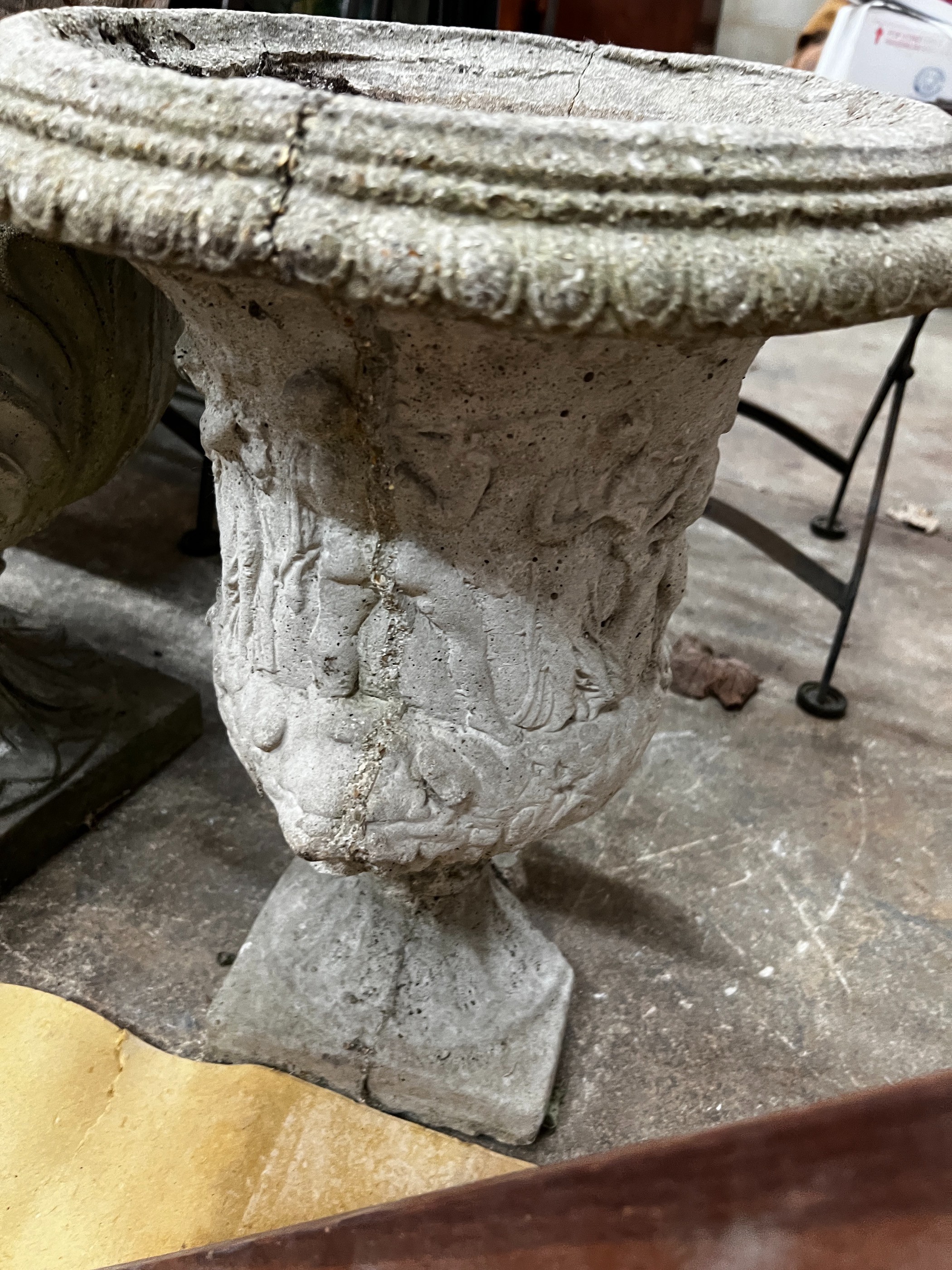 Three circular reconstituted stone garden urns, the largest diameter 48cm, height 55cm